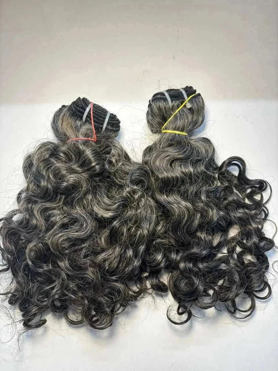 Bundles of textured kinky straight hair extensions with natural volume and machine weft