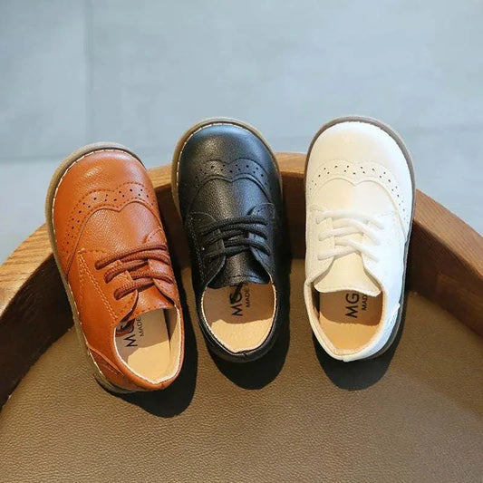 Leather kids shoes for baby boys and girls in brown, black, and white colors, breathable and lace-up design with rubber soles for casual wear.
